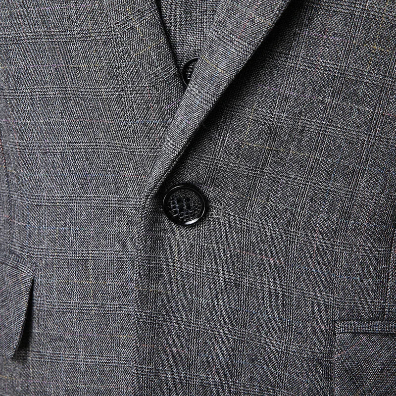 Close-up of gray plaid suit jacket with black button and textured fabric pattern