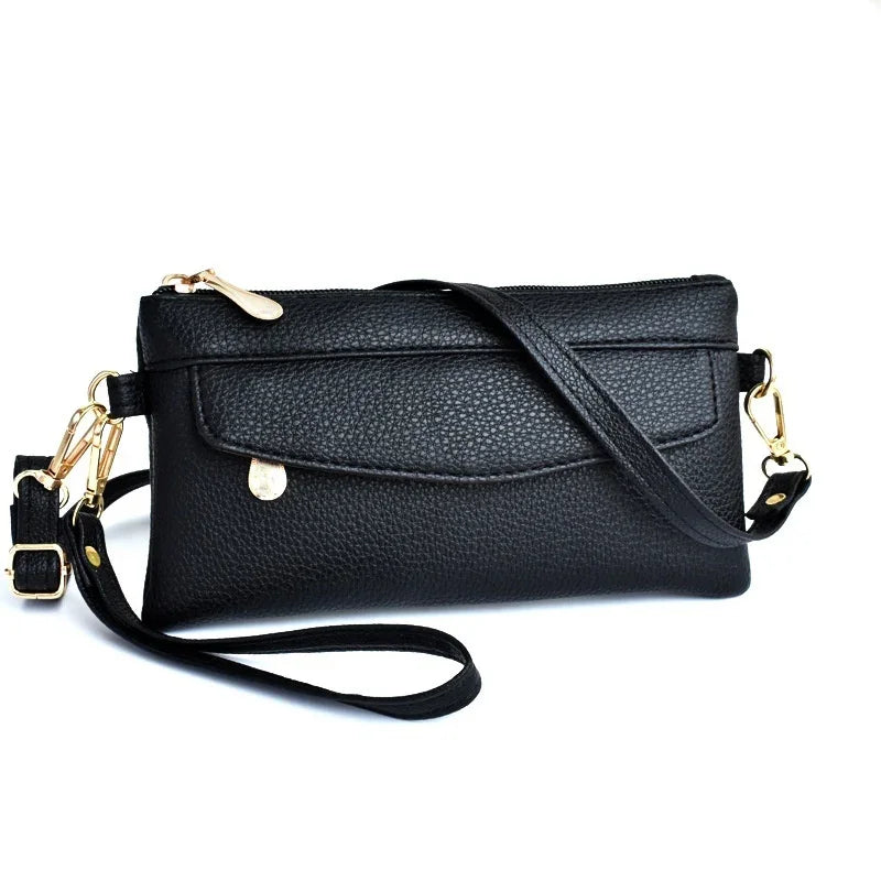 Black textured leather crossbody bag with gold hardware and front flap pocket