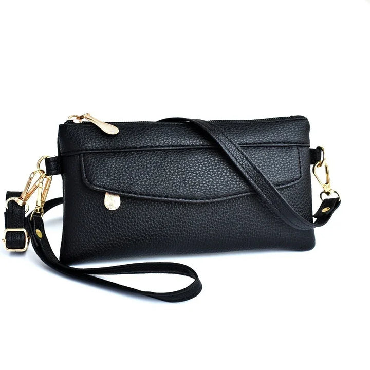 Black textured leather crossbody bag with gold hardware and front flap pocket