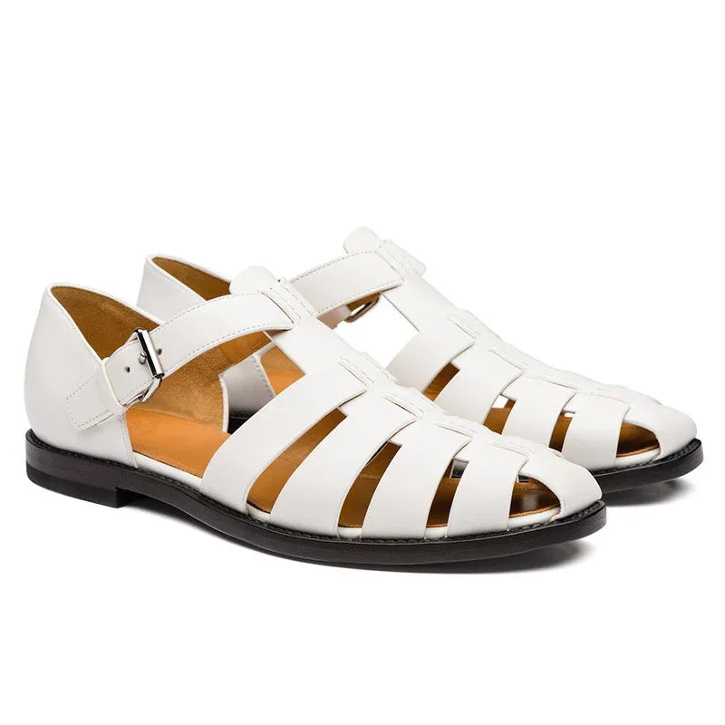 White leather men's fisherman sandals with buckle strap and black sole on white background