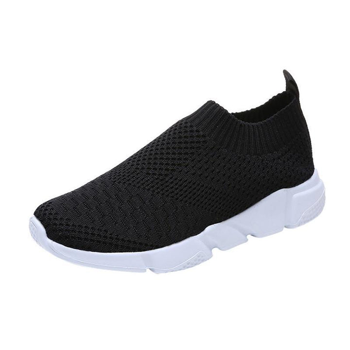 Black knit slip-on sneaker with white thick sole and pull tab on white background