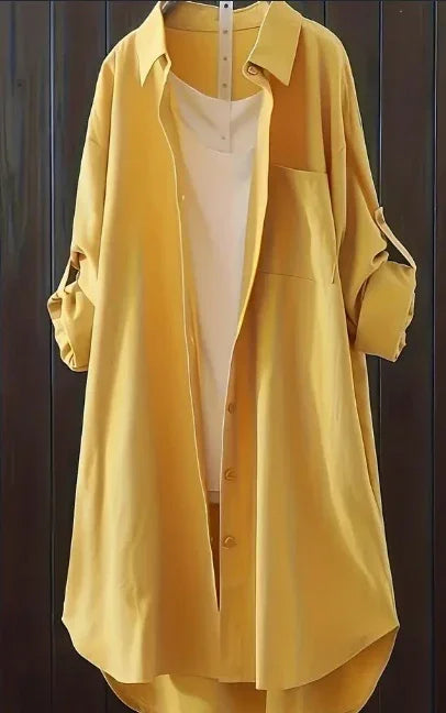 yellow long-sleeve shirt dress with front pocket paired with white sleeveless top on hanger