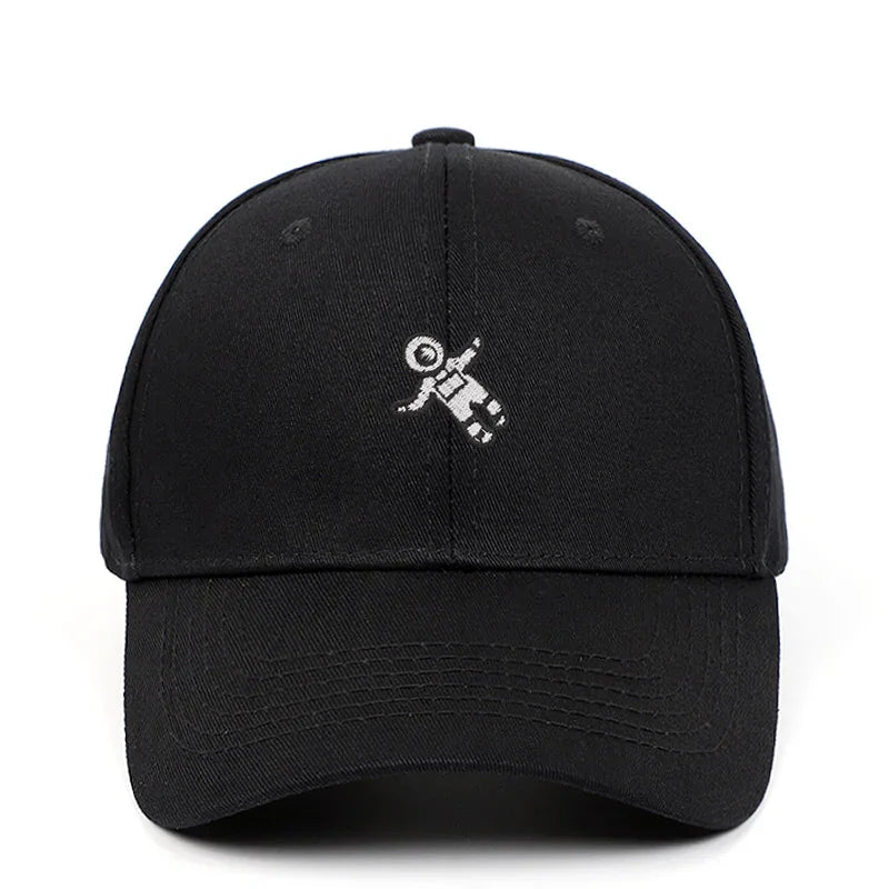 Black baseball cap with small white astronaut design embroidered on front