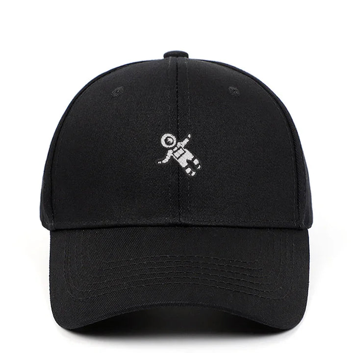 Black baseball cap with small white astronaut design embroidered on front