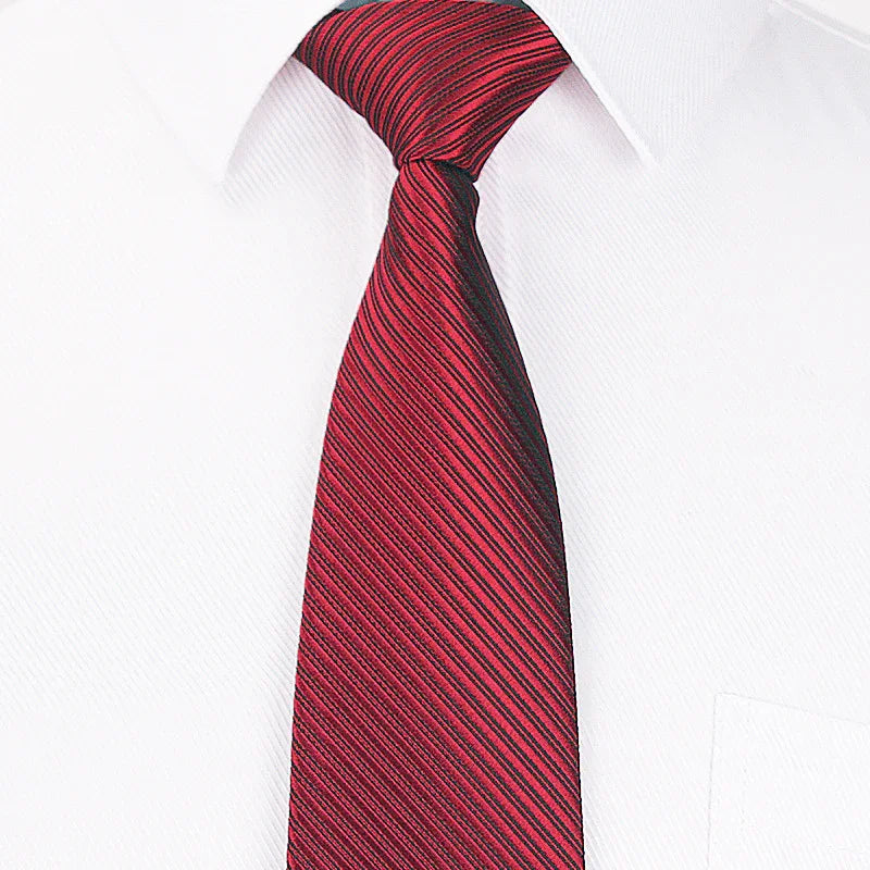 Red striped silk necktie tied in Windsor knot on white dress shirt collar
