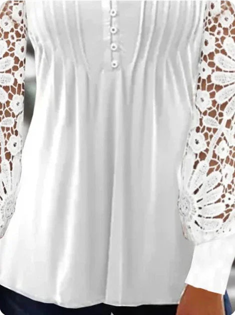 White blouse with floral lace sleeves, button-front detail, and pleated bodice