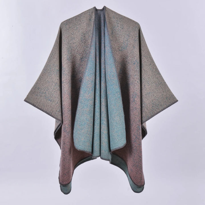 Reversible textured wool poncho with muted teal and brown tones against a white background