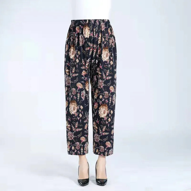 Black floral print women's ankle-length pants with elastic waistband styled with black heels