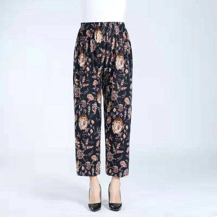 Black floral print women's ankle-length pants with elastic waistband styled with black heels