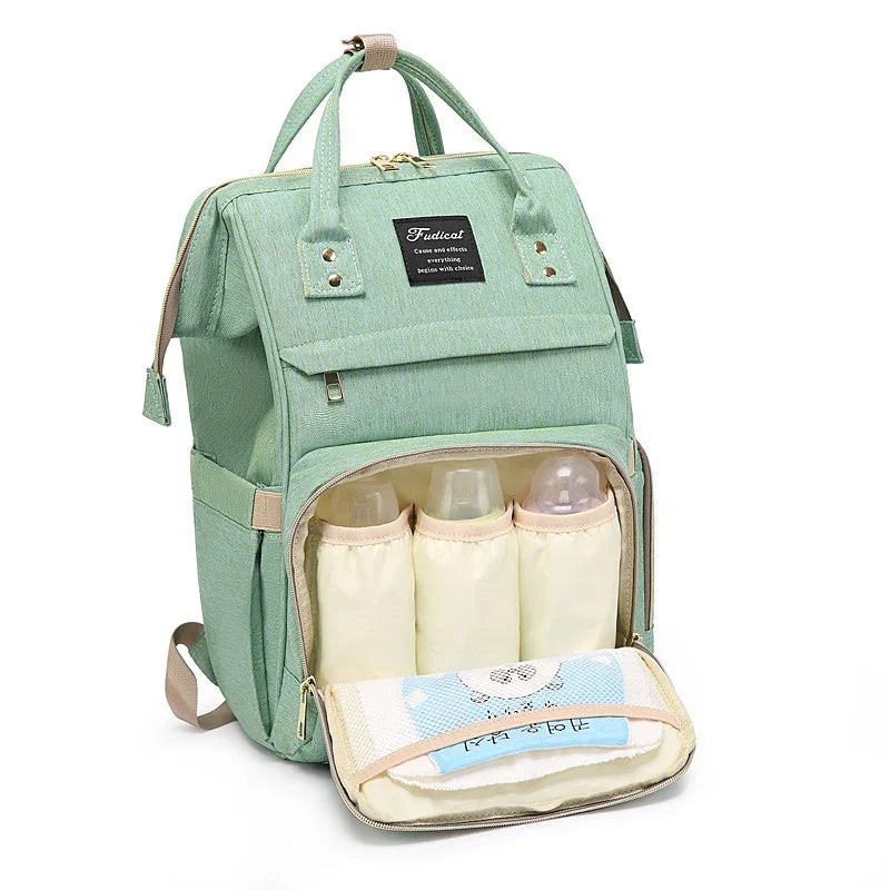 Mint green diaper backpack with insulated baby bottle holders and front zipper pocket for baby essentials