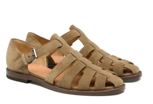 brown suede fisherman sandals with buckle straps and low heel on white background