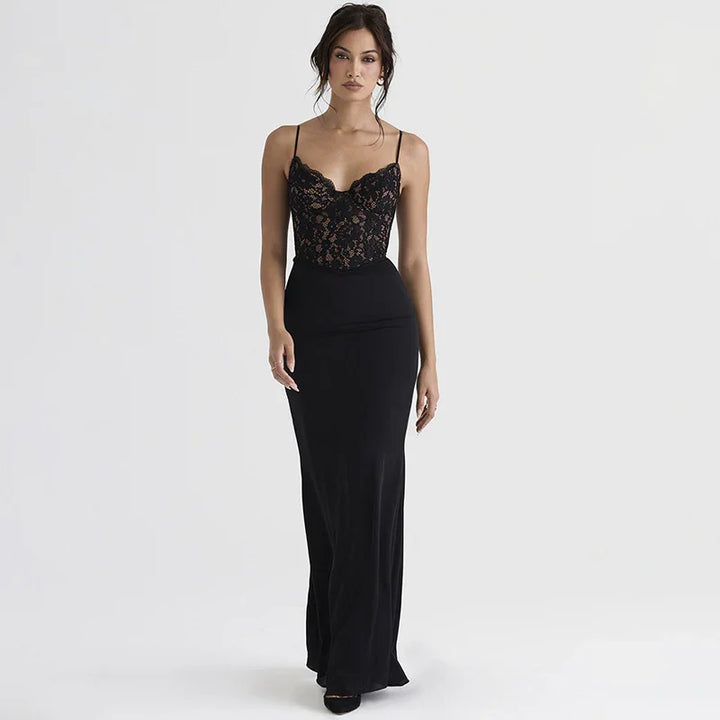 woman wearing elegant black lace bodice evening gown with thin straps on plain background