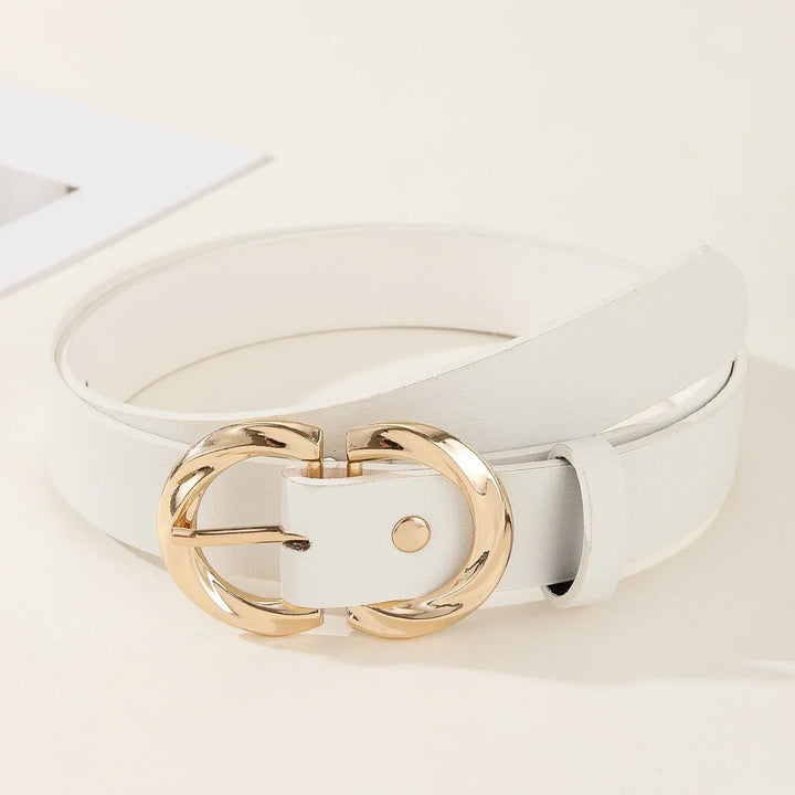 White leather belt with a shiny gold double ring buckle on beige background