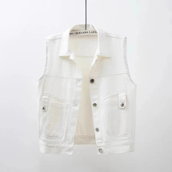 White sleeveless denim vest with button closure and front flap pockets on hanger