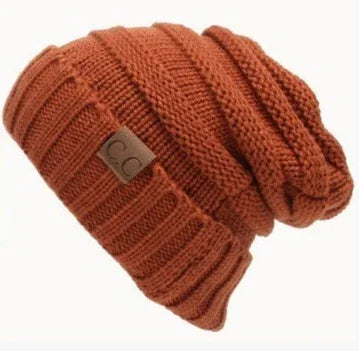 Rust-colored knitted slouchy beanie hat with ribbed cuff and CC brand leather patch