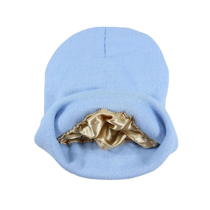 Light blue knit beanie hat with smooth beige satin lining inside for comfort and warmth