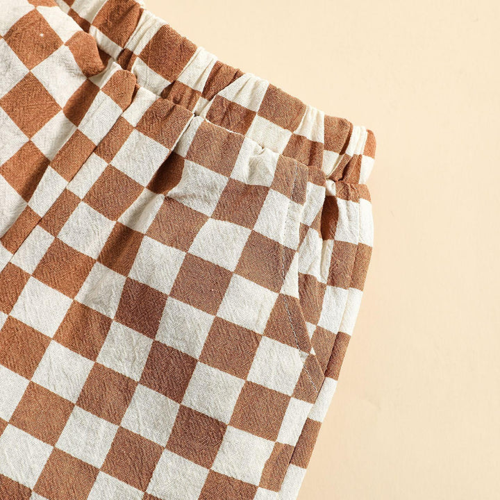 Close-up of elastic waist brown and white checkered fabric pants with side pocket