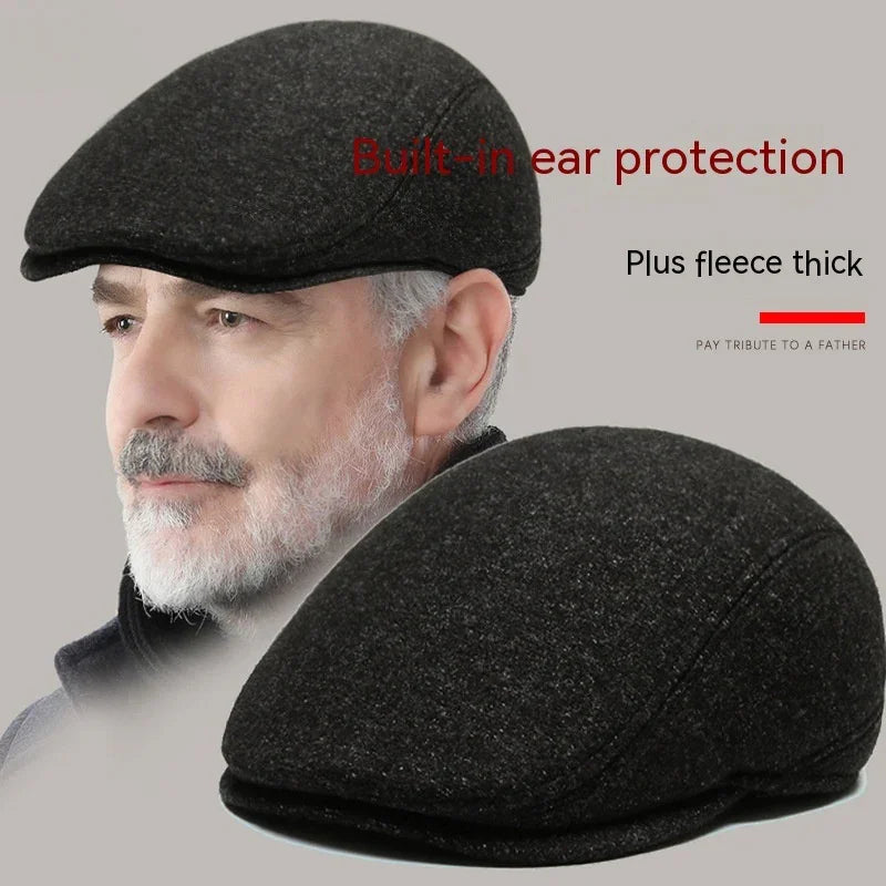 Gray flat cap with built-in ear protection and thick fleece, worn by a mature man with gray beard