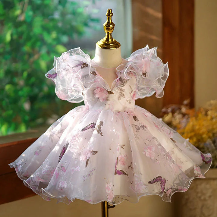 Elegant white floral baby dress with puff sleeves and butterfly prints on mannequin