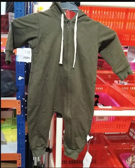 Olive green hooded baby jumpsuit with front zipper and white drawstrings displayed in a store setting