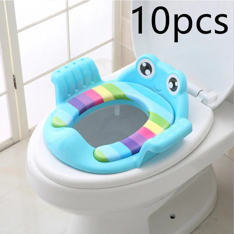Blue frog-shaped toddler potty training seat with rainbow stripes on white toilet
