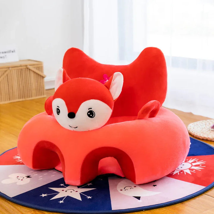 Red plush children's chair with fox face design on colorful star and moon patterned rug