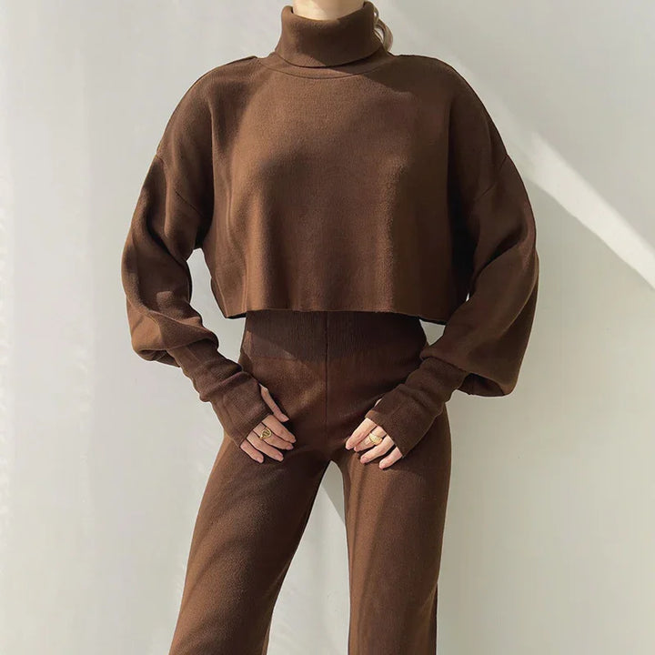 Woman wearing brown cropped turtleneck sweater and high-waisted fitted pants in soft knit fabric
