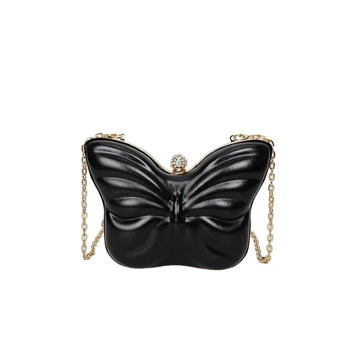 Black butterfly-shaped evening clutch bag with gold chain strap and rhinestone clasp