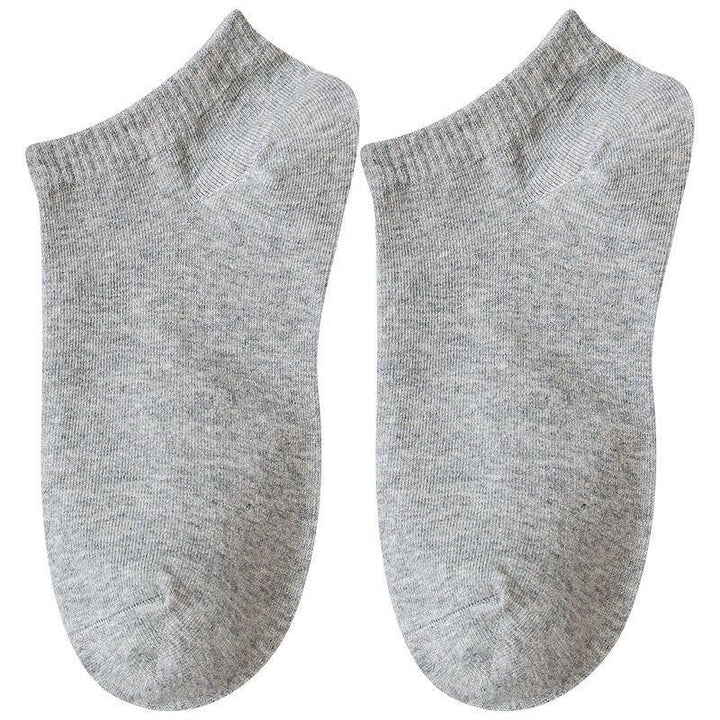 Pair of plain grey ankle socks made of soft knit fabric on white background