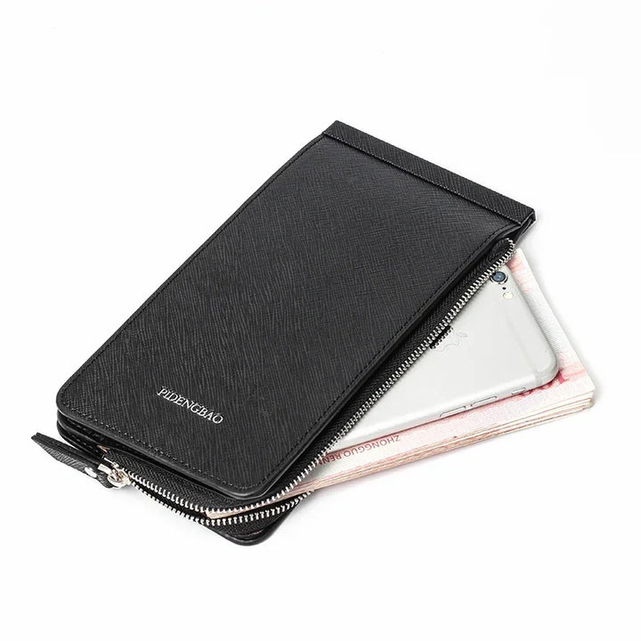 Black zippered leather wallet with textured finish holding smartphone and Chinese currency notes