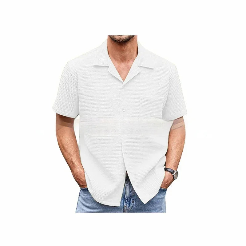 Man wearing white textured short-sleeve button-up shirt with collar and blue jeans