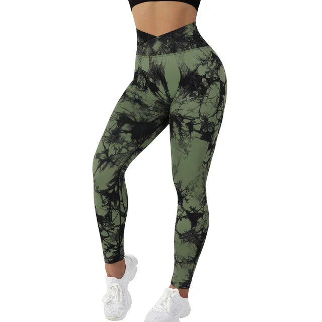 Woman wearing high-waisted green and black tie-dye leggings with white sneakers