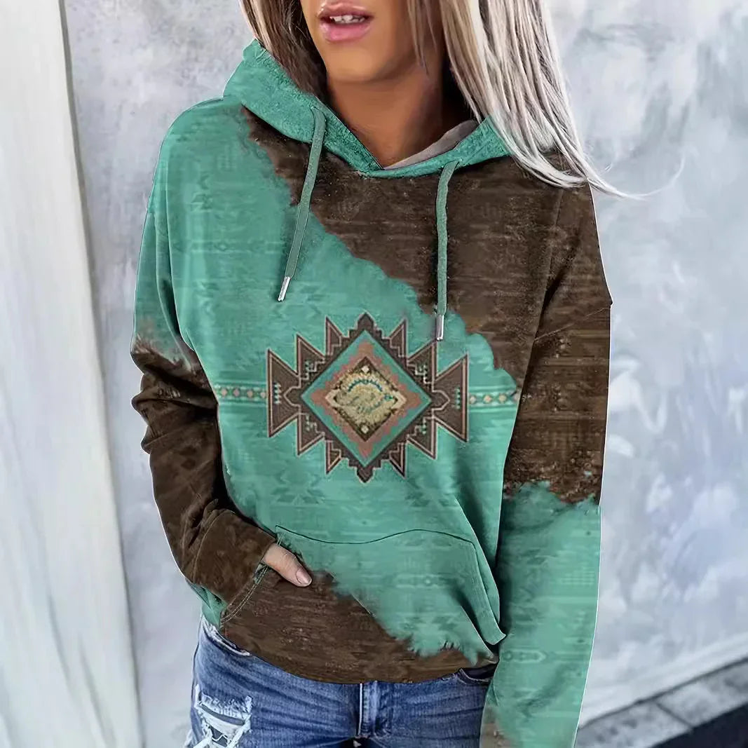 Woman wearing teal and brown hoodie with geometric southwestern pattern and drawstrings