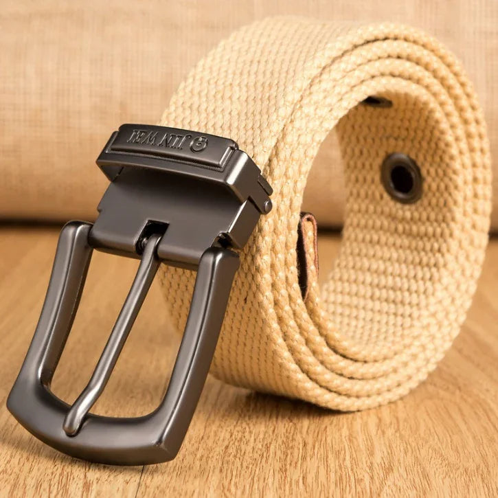 Beige woven fabric belt with matte black metal buckle on wooden surface