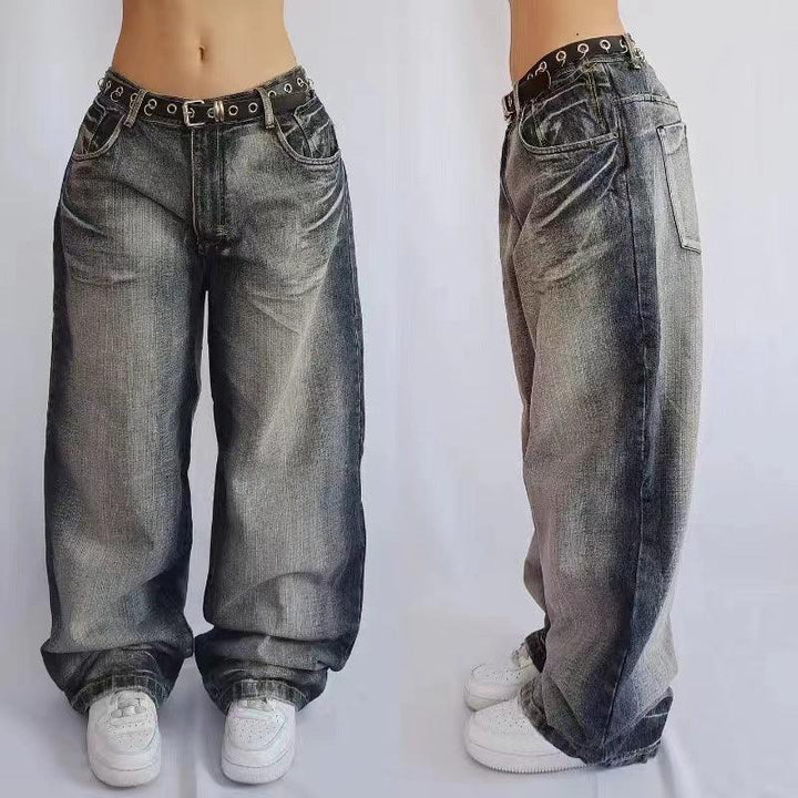 Front and side view of baggy faded black denim jeans with grommet belt and white sneakers