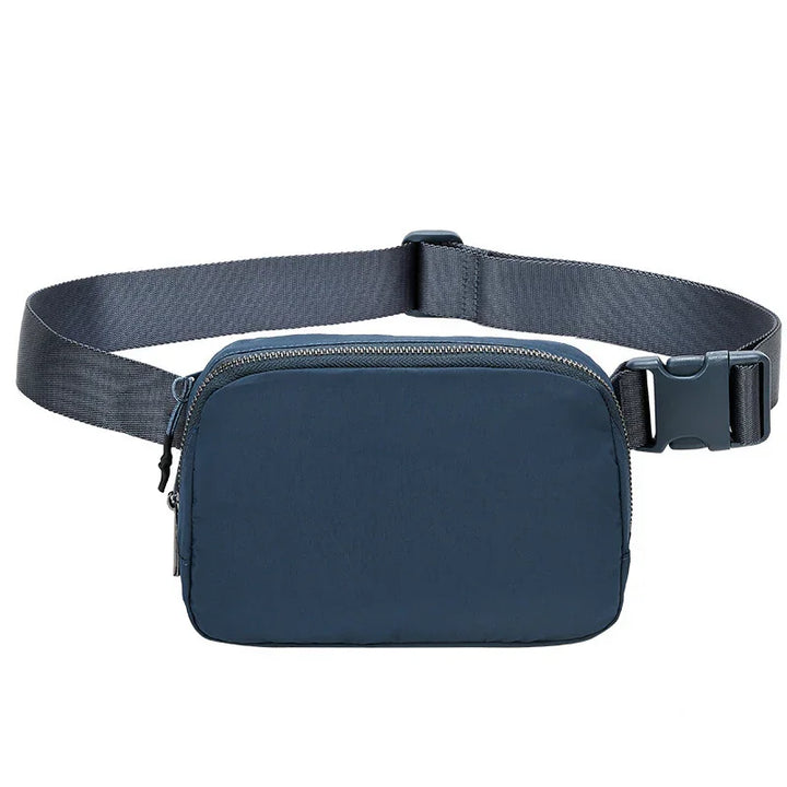 Compact navy blue waist bag with adjustable black strap and zipper closure