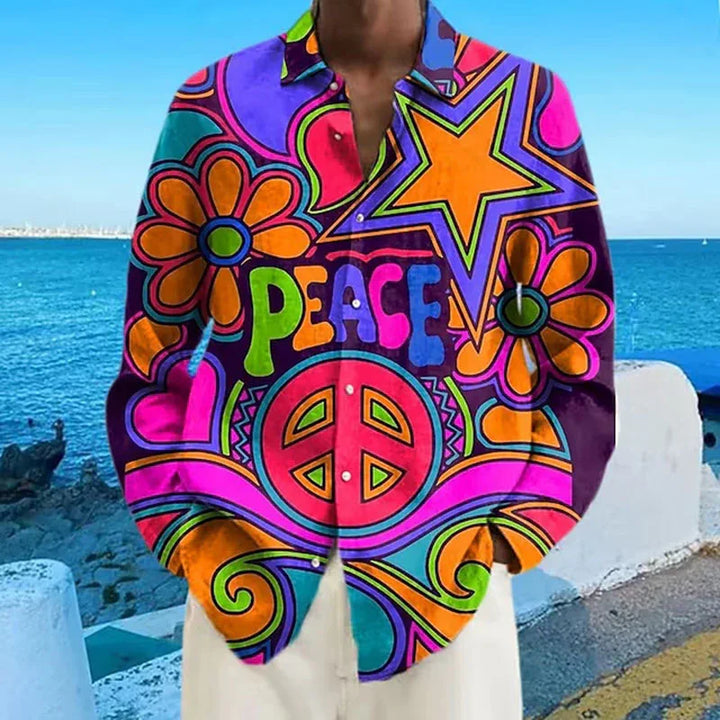 Colorful psychedelic shirt with peace sign, flowers, stars, and bold peace lettering by the seaside