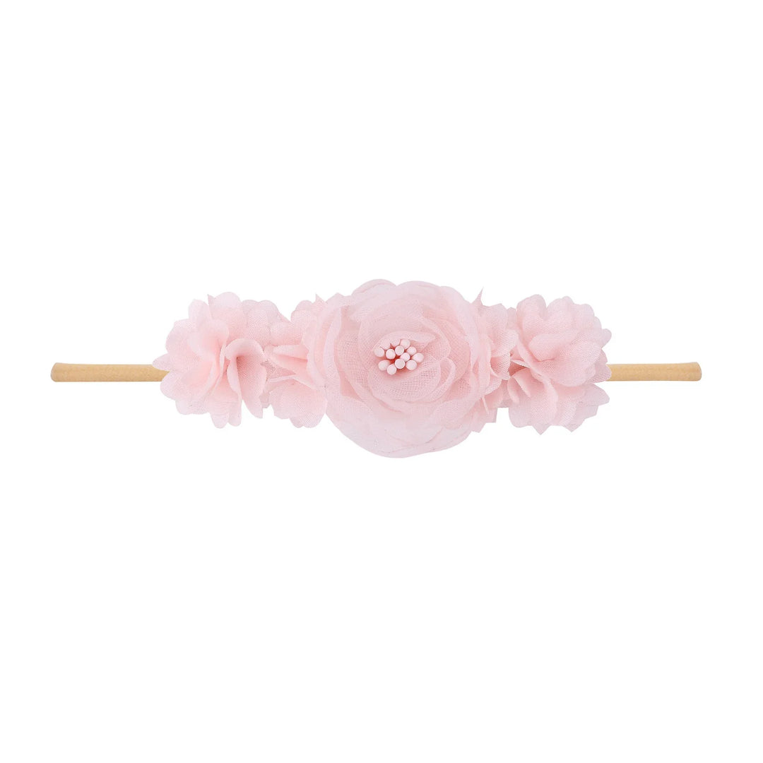 Pink fabric flower headband with layered petals on elastic band