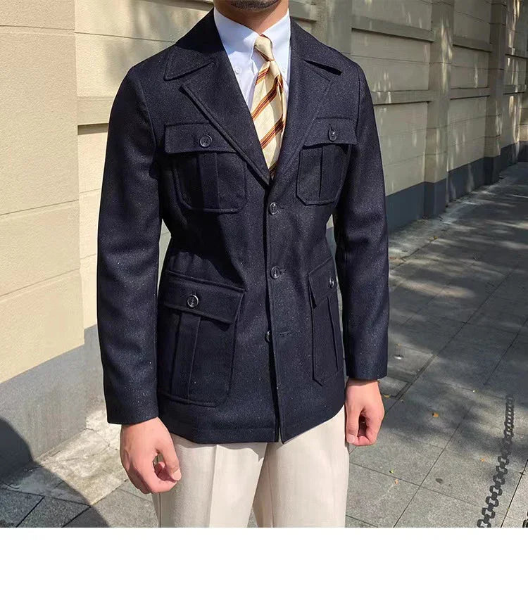Man wearing navy blue wool buttoned blazer with four front pockets, striped tie, white shirt, and beige pants outdoors
