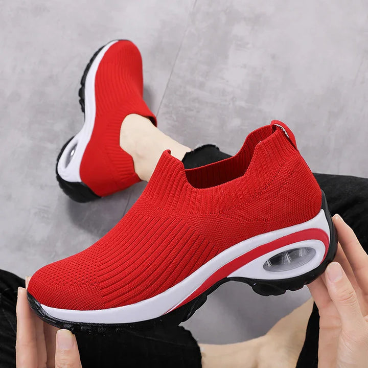 Red slip-on knit sneakers with white sole and black tread, lightweight sporty design