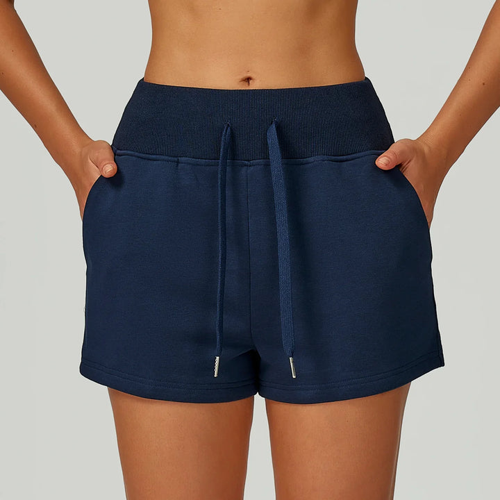 Close-up of woman wearing navy blue casual drawstring shorts with pockets