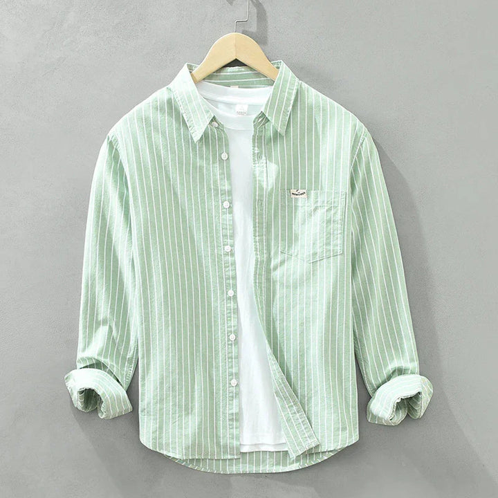 Light green men's striped button-up shirt with white inner t-shirt on wooden hanger