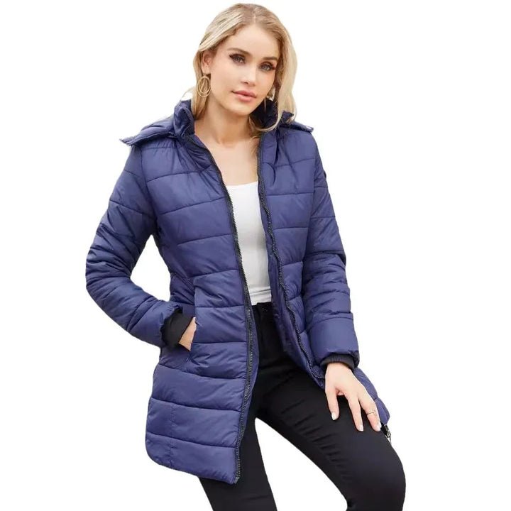Woman wearing a navy blue quilted puffer jacket with zipper, paired with black pants and white top