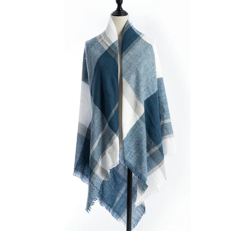 Blue and white plaid shawl with fringed edges displayed on dress form