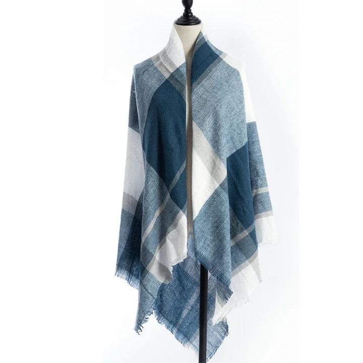 Blue and white plaid shawl with fringed edges displayed on dress form