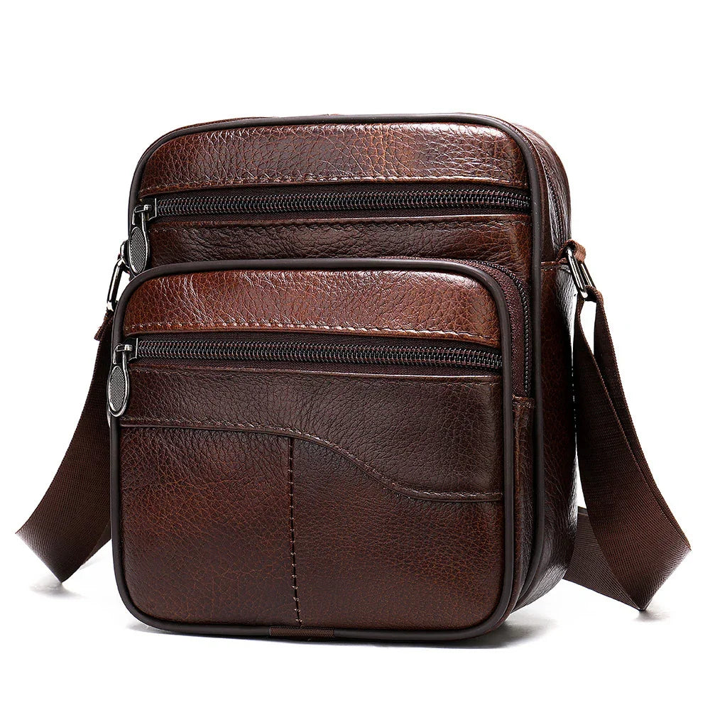 Brown leather crossbody bag with two zippered front pockets and adjustable strap