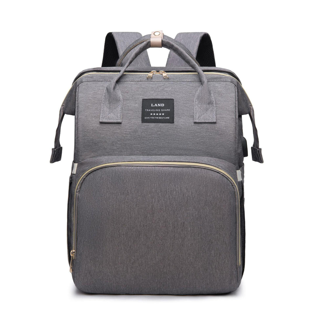 Gray modern travel backpack with front zipper pocket and top handles on white background
