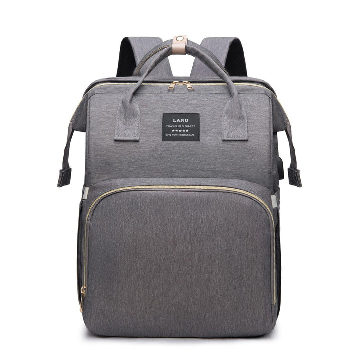 Gray modern travel backpack with front zipper pocket and top handles on white background