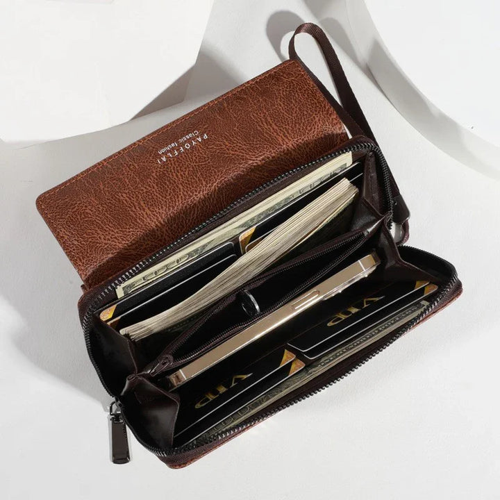 brown leather wallet open showing cash, credit cards, and a smartphone inside on white background