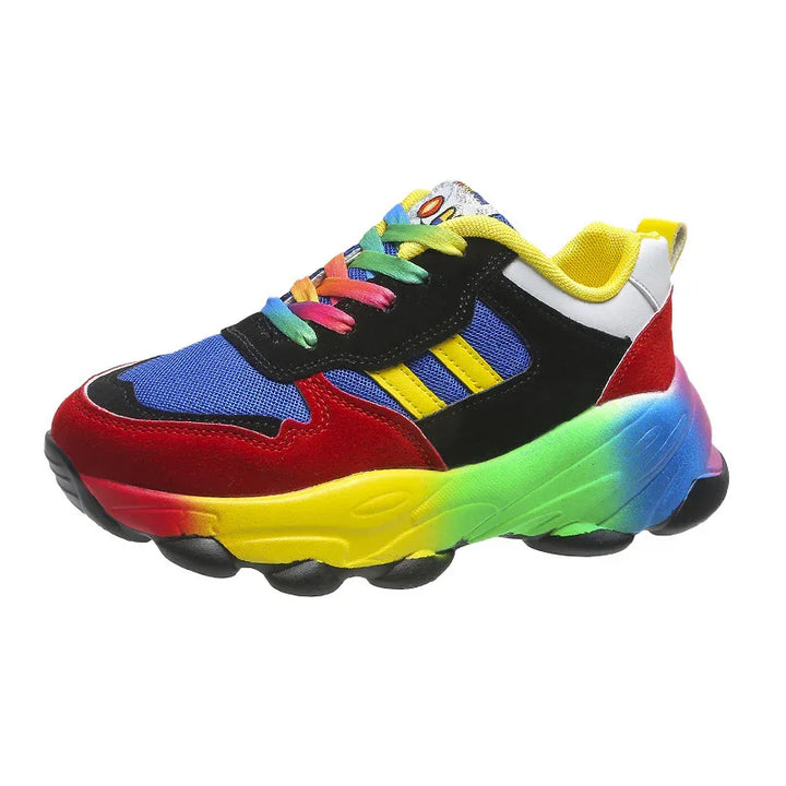Colorful sneaker with rainbow sole, red, black, blue mesh upper, yellow stripes, and multicolor laces